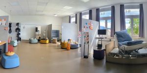 Innenraum des HealthLab, Raumtrenner, die verschiedene Exponate wie Pflegebett und Roboter räumlich voneinander abbildet
